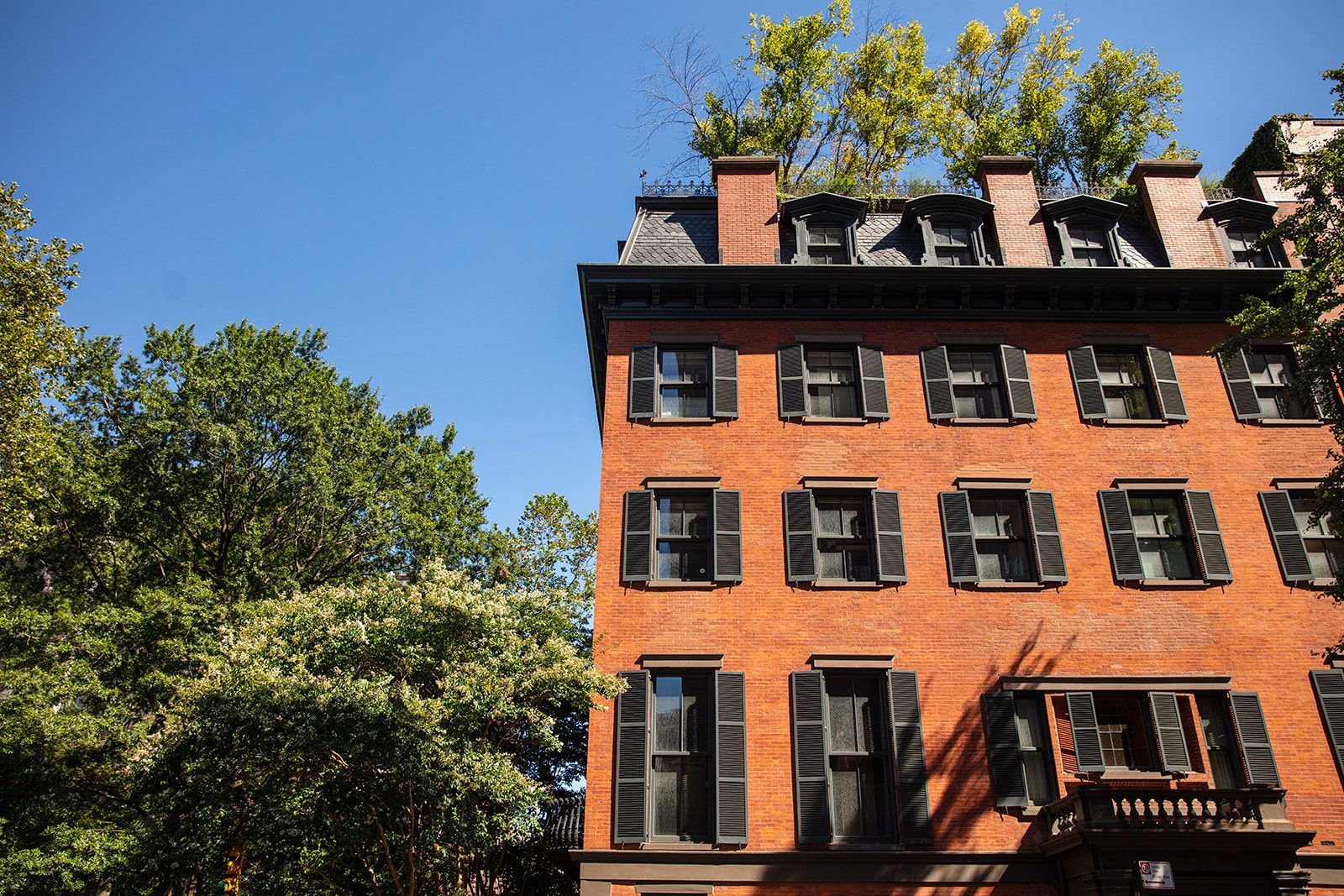 A classic red-brick Gramercy facade beneath a mansard roof